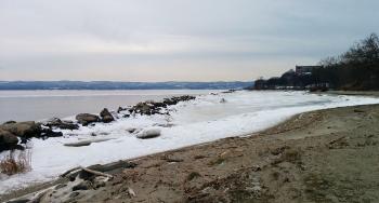 Beach view of partially frozen Hudson River