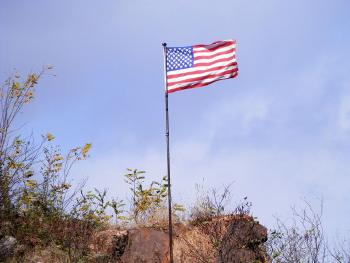 Flag atop rock outcropping near Rt 9/9A split