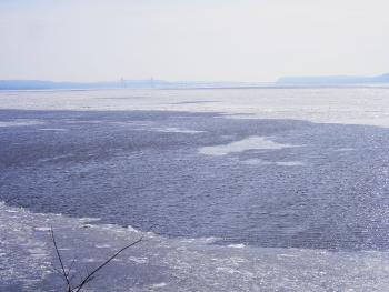 Southern somewhat frozen Hudson River view from Teller's Point at Croton Point Park. New Tap Zee bridge in foggy distance.