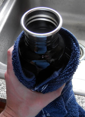 3. Use proper safeguards or techniques. My device pours directly into the bottle, so I use a thick kitchen towel to hold it without burning my fingers. You can of course pour directly into the bottle, or use an intermediary (measuring cup, funnel, etc.). © 2016 Peter Wetzel.